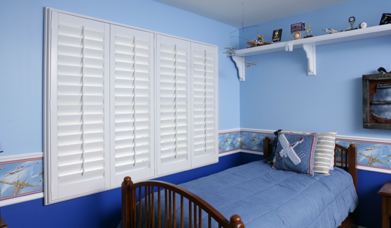 White plantation shutters in blue kids bedroom in Sacramento 